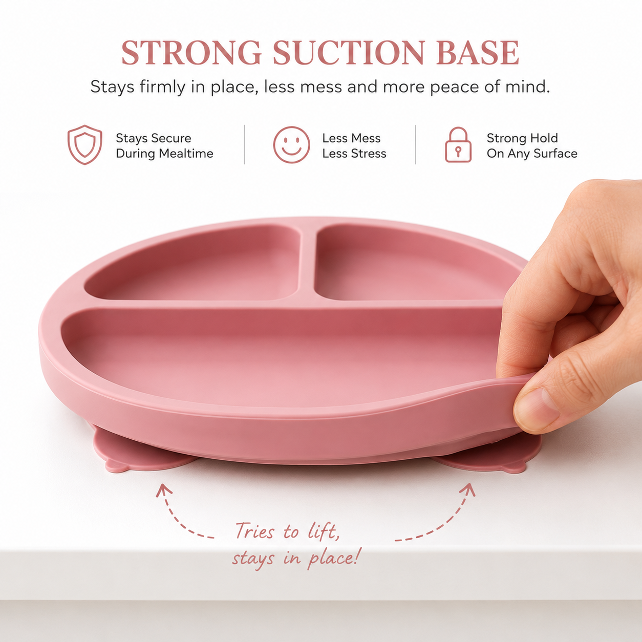 A pink silicone baby feeding tray with suction cups, shown with a hand lifting the edge to demonstrate its strong suction base. The image includes marketing text and icons explaining the product's features.